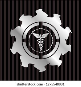 Caduceus medical icon inside silvery shiny badge