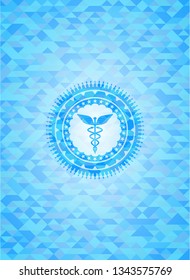 Caduceus medical icon inside sky blue emblem with mosaic background