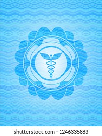 Caduceus medical icon inside water wave representation badge background.