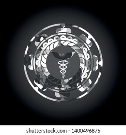 Caduceus medical icon on grey camouflage pattern
