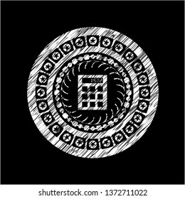 calculator icon inside chalk emblem written on a blackboard