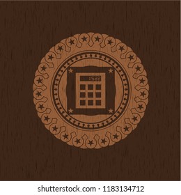calculator icon inside realistic wood emblem