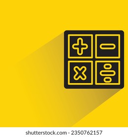 calculator with shadow on yellow background