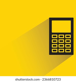 calculator with shadow on yellow background
