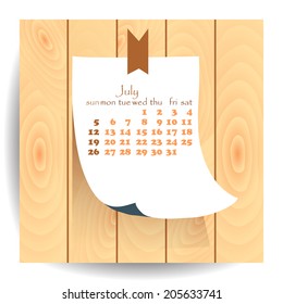 Calendar 2015 July: label sheet of paper on the wooden textured background.