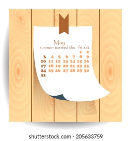 Calendar 2015 May: label sheet of paper on the wooden textured background.