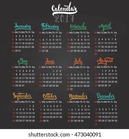 Calendar 2017 design template vector isolated on the black chalkboard background. The first day of the week is Sunday. Set of 12 months lettering inscription, separate on colorful season.