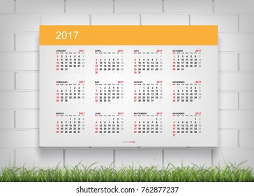 Calendar 2017 on white paper background with white brick wall and green grass. Vector illustration.