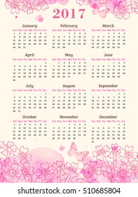 Calendar for 2017 year. Abstract background with pink watercolor blots, flowers and butterflies.