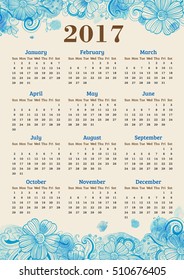 Calendar for 2017 year. Abstract floral background with blue watercolor blots.