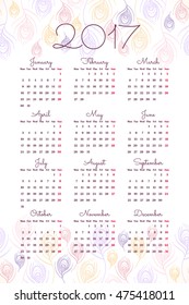 Calendar for 2017 year with stylized linear peacock feathers. Week starts from Monday