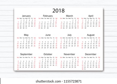 Calendar 2018 year in simple style on white wooden texture background. Week starts from Sunday. Vector illustration.