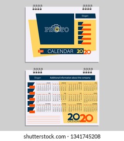 Calendar 2020 with place for photo. Week starts with sunday. Design template using yellow, red and blue colors on a light background. Desktop calendar template.