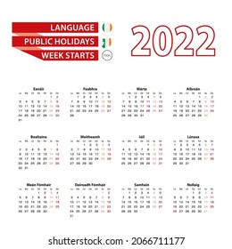 Calendar 2022 in Irish language with public holidays the country of Ireland in year 2022. Week starts from Monday. Vector Illustration.