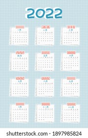 Calendar for 2022 from January to December, Chinese language. Every month is on squared paper with dots, piece of newspaper is at the bottom, pink scotch, color patterned adhesive tape is on the top