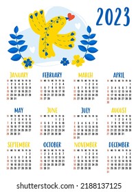 Calendar for 2023 with cute decorative yellow-blue bird with heart. Vector illustration. Vertical template for 12 months in English. The week starts on Sunday. Stationery, printing, organizer, decor