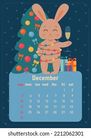 Calendar 2023 for december. Year of rabbit, symbol of new year. The week starts on Sunday. A cute rabbit turned into garland with colored light bulbs, stands near Christmas tree with gifts with glass 