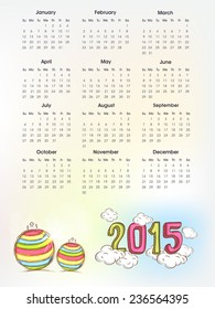 Calendar with colorful text 2015 on clouds and X-mas balls for Happy New Year celebrations.