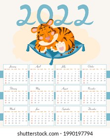 diseño de calendario para 2022 con un cubo de tigre durmiendo en una almohada.
concepto de Año Nuevo 2022 según el calendario chino. Año del tigre.
El tigre naranja de los niños es adorable.