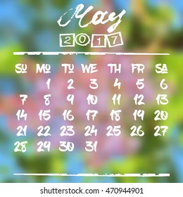 Calendar design grid in hand written style with white lettering and dates of spring month May 2017 on natural blurred background. Branch of lilac. Vector illustration