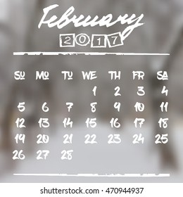 Calendar design grid in hand written style with white lettering and dates of winter month February 2017 on natural blurred background. Snowy landscape. Vector illustration