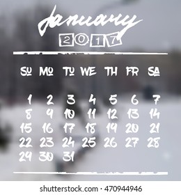 Calendar design grid in hand written style with white lettering and dates of winter month January 2017 on natural blurred background. City park in snow. Vector illustration
