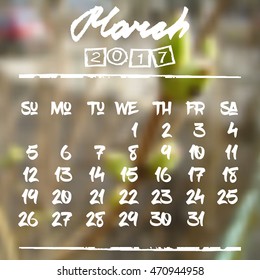Calendar design grid in hand written style with white lettering and dates of spring month March 2017 on natural blurred background. First buds on branch. Vector illustration