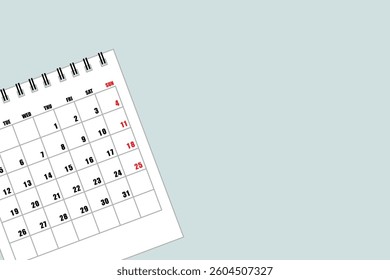 Calendar with empty copy space to list the month and year on a light blue background, flat view or top view with the calendar on the left and text space on the right.