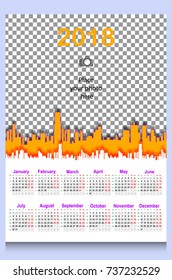 Calendar grid for 2018 year. Design template. Week starts on Monday. Background with place for photo. Silhouette of city houses skyscrapers. White and yellow background color. Vector illustration.