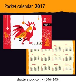 Calendar for year 2017 with vector silhouette cock and christmas decoration on color background. Design Illustration vector calendar with symbol year red rooster 2017.