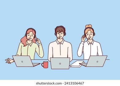 Call center employees with headsets for telephone sales sit at table with laptops and advise potential buyers. Call center with business people talking to clients via IP telephony.