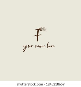 Calligraphic letter F logo with oack leaf.Typography vector icon with nature element.