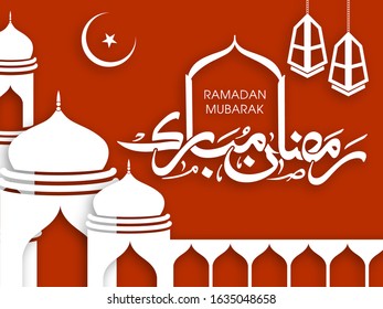 Calligraphic text of Ramadan Mubarak translated in Arabic language with lamps and Mosque to celebrate Muslim community festival.