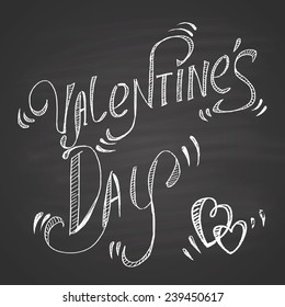 Calligraphy chalk on a blackboard: Valentine's Day.