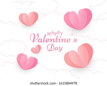 Calligraphy Happy Valentine's Day Text on White Cloud Background Decorated with Red and Pink Paper Cut Hearts.