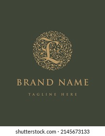 Calligraphy inspired flourished logo design with the capital letter L. 