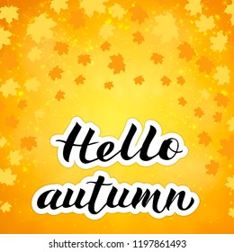 Calligraphy lettering Hello autumn written with brush on bright yellow and orange background. Falling leaves confetti. Autumn fall vector illustration. Easy to edit template for your design projects.