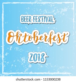 Calligraphy lettering of Oktoberfest Beer festival 2018 in orange and blue with white outline on blue textured background for decoration, banner,poster, invitation, advertising,greeting card