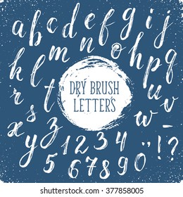 Calligraphy letters hand drawn with dry brush. Handwritten alphabet on blue background. Hand drawn calligraphy. Modern inc typography.