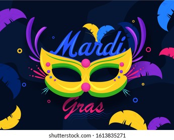 Calligraphy Mardi Gras Text with Party Mask and Colorful Feather Decorated on Blue Abstract Background.