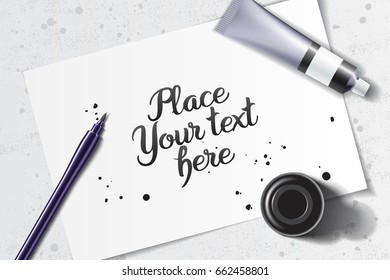 Calligraphy mockup with brush pen and black ink bottle on the background of white sheet of paper and grunge table