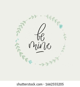 Calligraphy phrase "Be mine". Hand lettering brush. Plant wreath. Vector. Cyrillic. Russian phrases with a brush.