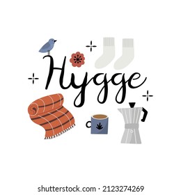 Calligraphy text lettering Hygge, decorated with blanket, coffee pot, mug and warm socks. Isolated hand drawn vector illustration