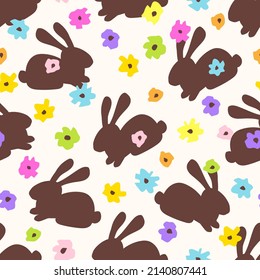 Calm gentle floral vector seamless pattern. Multi-colored flowers, chocolate rabbit on a light background. For printing fabrics, textile products. Spring summer collection. Easter decor.