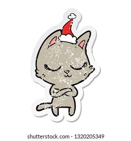 calm hand drawn distressed sticker cartoon of a cat wearing santa hat
