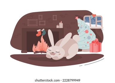 Calm sleeping cute rabbit at home next to the fireplace, waiting for Santa. Cozy festive concept. Christmas night. New Year's card. Decorated big spruce with small red gift under it. Kindled fireplace