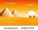 Camel caravan at pyramids in sunset