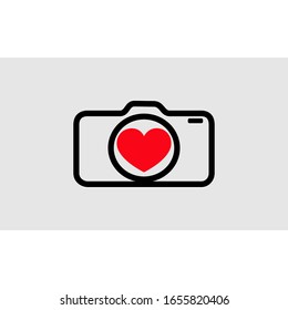 the camera is black. The lens has a red heart picture. for the icon for photography lovers. the symbol of the camera shop
