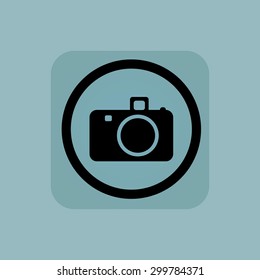Camera in circle, in square, on pale blue background