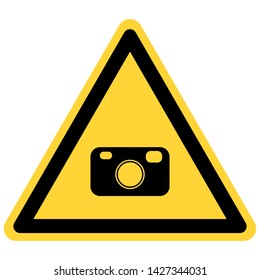 Camera and danger sign on white